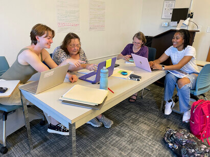 Four people working at a table