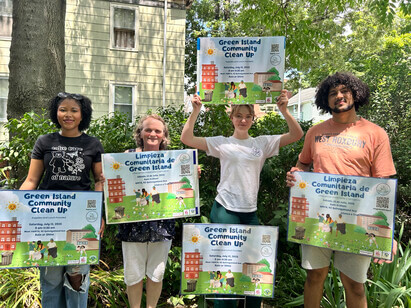 People holding up community clean up signs