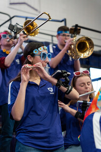 Band members playing in the stands while wearing fun sunglasses