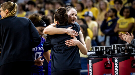 Basketball player hugging coach