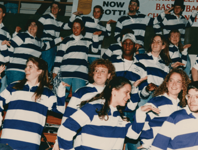 People in purple and white striped shirts dancing