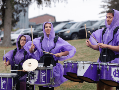 Drummers in purple ponchos