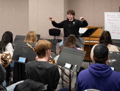 Student conducting band members