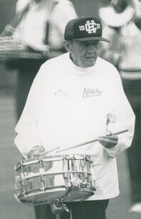 Old man plays the snare drum