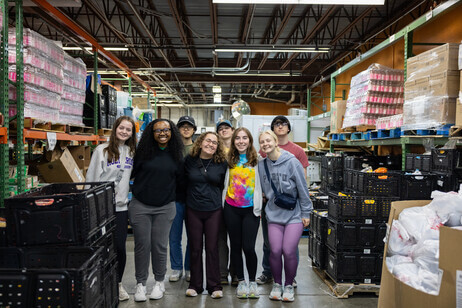 Group of students in between shelves of food