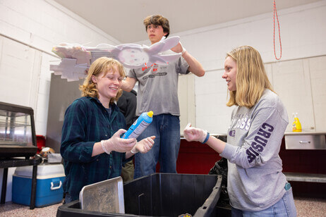 Three students cleaning