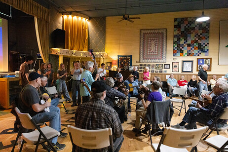 Group of musicians sitting in a circle