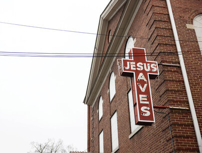 Jesus Saves cross on the side of a building