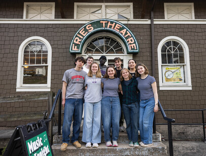 Group of students standing in front of a "Fries Theatre" sign