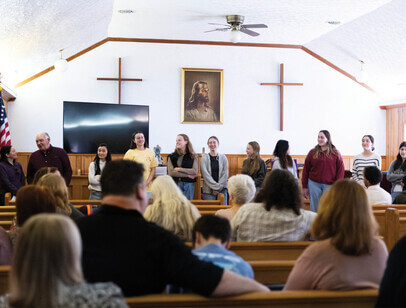 People standing at the front of church