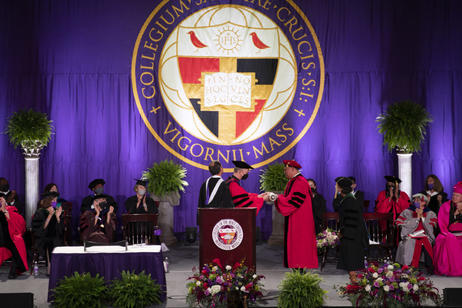 President Vincent Rougeau receiving the mace from President Emeritus Rev. Philip L. Boroughs, S.J. Photo by Matt Wright