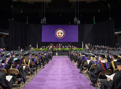 Students wait to receive their diplomas.