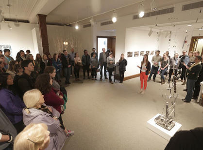 Senior studio art major Mary Welsh '17 speaks to a crowded Cantor Art Gallery about her sculpture "Eruption" during the Academic Conference.