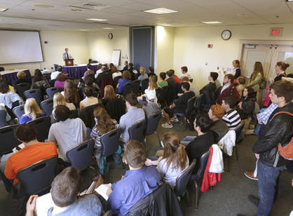 Ryan Kingsley '17, in the departmental English honors program, presents his senior thesis "Bird on the Horizon" to a packed room in the Hogan Campus Center during the Academic Conference.