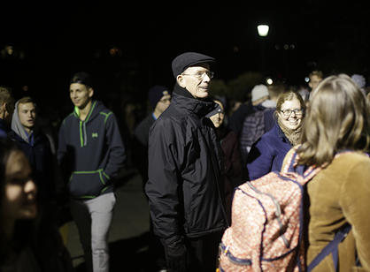 Rev. Philip L. Boroughs, S.J., president of Holy Cross, joins the community for the Christmas tree lighting ceremony.
