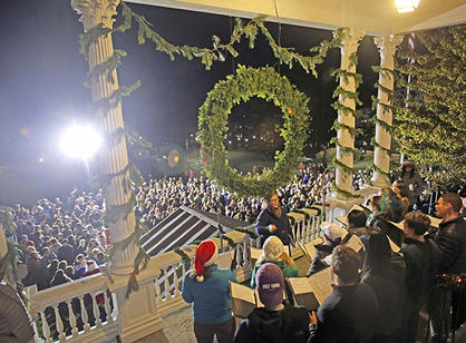 The Holy Cross Chamber Singers perform on the O’Kane Porch before community members gathered at the Christmas tree lighting ceremony.