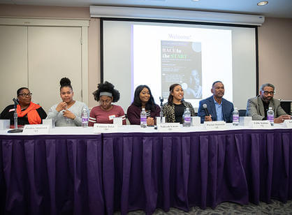 Students stand in front of a line of tall rubber boots before heading into the Blackstone River.