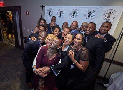 A group of alumni pose for a photo.