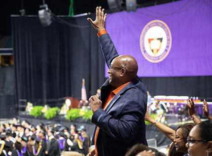 A family member waves from the crowd.