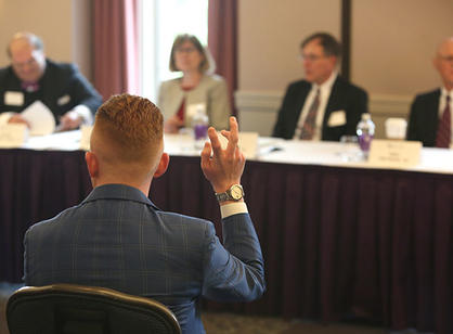 A student asks the panelists a question.