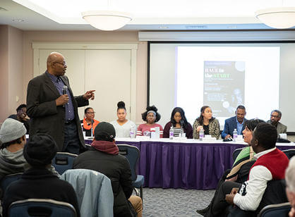The Rhythm Nation Steppaz perform in front of a large Holy Cross 175th logo