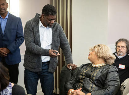 A student decorates a donut on the Kimball quad