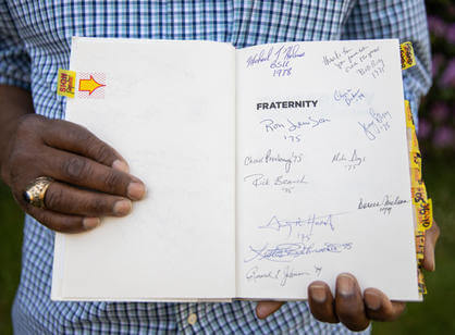 Signatures from alumni of color in De Leaver's copy of "Fraternity"