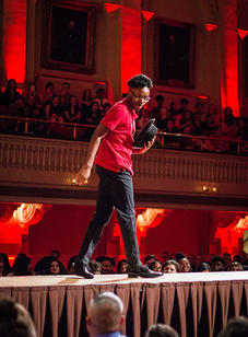 A student walks down the catwalk during the red scene of the BSU 20th Annual Fashion Show.