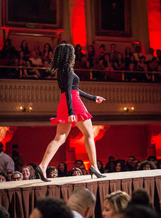 A student walks down the catwalk during the red scene at the BSU 20th Annual Fashion Show.