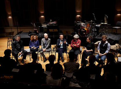 A group of people sit on stage