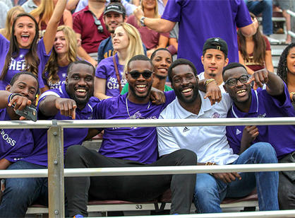 Holy Cross fans laugh at camera in the stands
