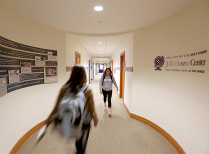 Students walk past the new sign for the J.D. Power Center for Liberal Arts in the World in Smith Hall
