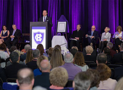 Nate Pine, director of athletics at Holy Cross, speaks during the dedication celebrations.