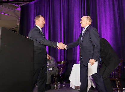 Nate Pine, director of athletics, shakes the hand of John Luth ’74, who alongside his wife, Joanne Chouinard-Luth, made a substantial gift of $32.5 million for the renovation and expansion of the Hart Center at the Luth Athletic Complex..