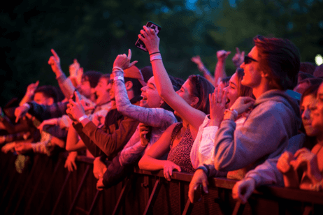 Students watch a concert in a crowd on campus.