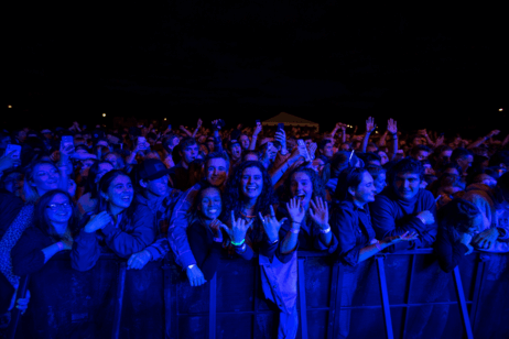 Students watch a concert in a crowd on campus.