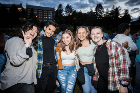Students pose together for a photo at a campus concert.