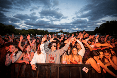 Students watch a concert in a crowd on campus.
