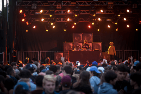 A DJ performs at a campus concert.