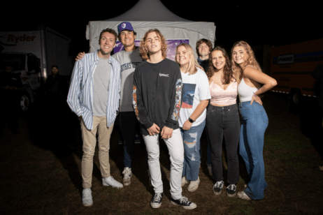 Students pose with the concert performer.