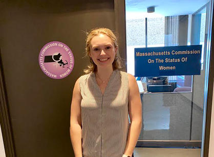 A student stands outside an office