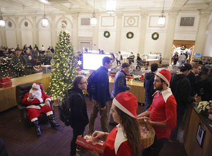 Students say “Hi” to Santa as they enter Kimball Hall for the annual holiday dinner.