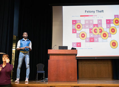 DeRay McKesson stands on stage in the Hogan Ballroom