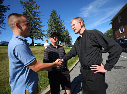 father boroughs greets a student and his father