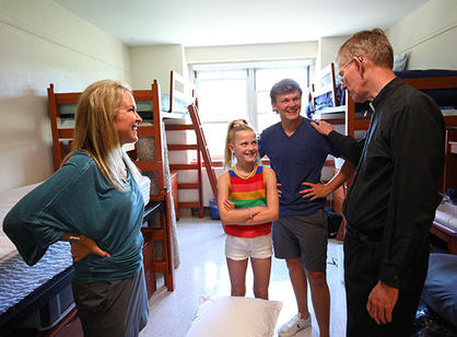 father boroughs talks to a student and his family