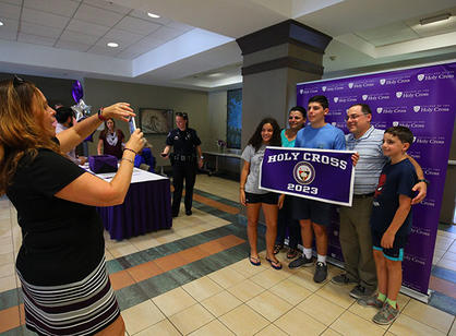 a student and his family take a picture