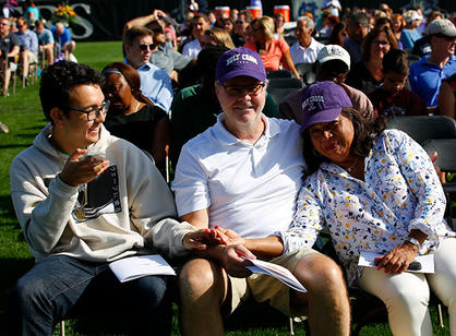a student sits with his parents