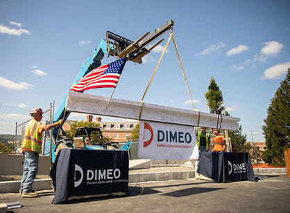 A forklift lifts the beam