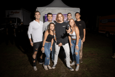 Students pose with the concert performer.