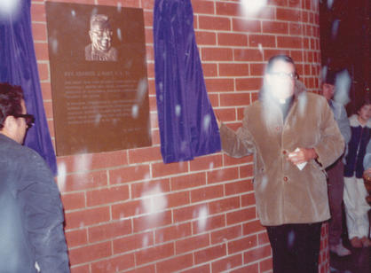 Former President Rev. John E. Brooks, S.J. '49 reveals the bronze placard at the grand opening of the Hart Center in January 1976. At the very bottom of the image you can see one corner of a gray rectangle.